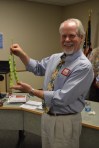 Dr. Hewins shows off giant beans from the district garden