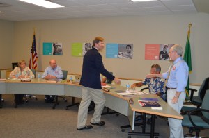 Doug Carlson is congratuated by the board members after his selection to fill Reva Palmer's open seat